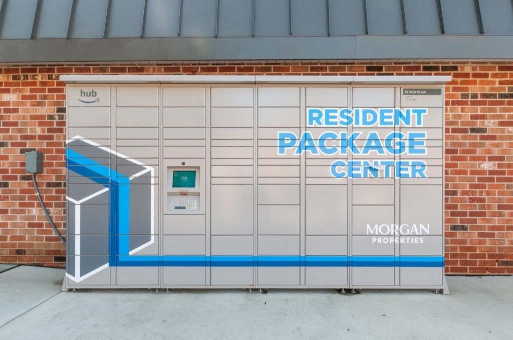 the door to the resident package center outside of a brick building