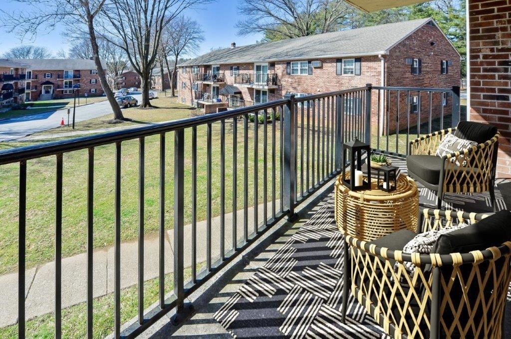 our apartments have a spacious balcony with chairs and a table