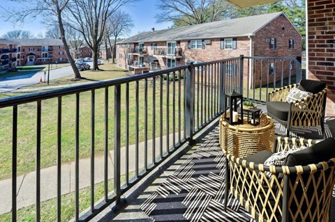 our apartments have a spacious balcony with chairs and a table