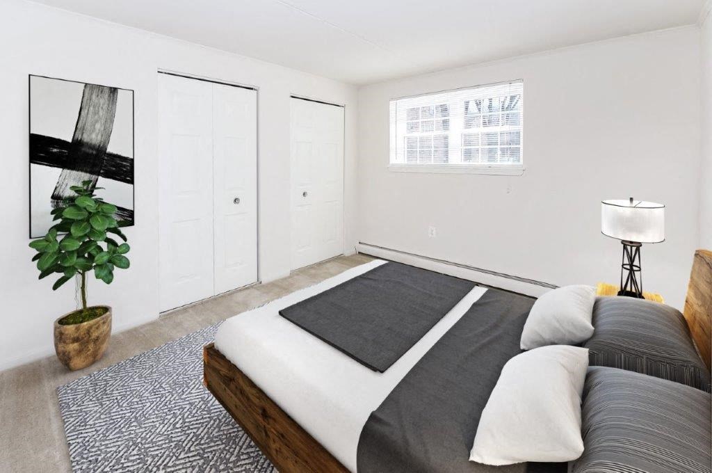 a bedroom with a bed and a potted plant