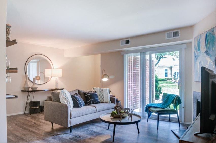 a living room with a couch and a sliding glass door