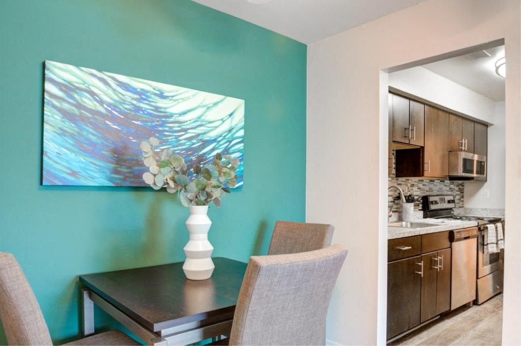 a kitchen and dining room with a table and chairs