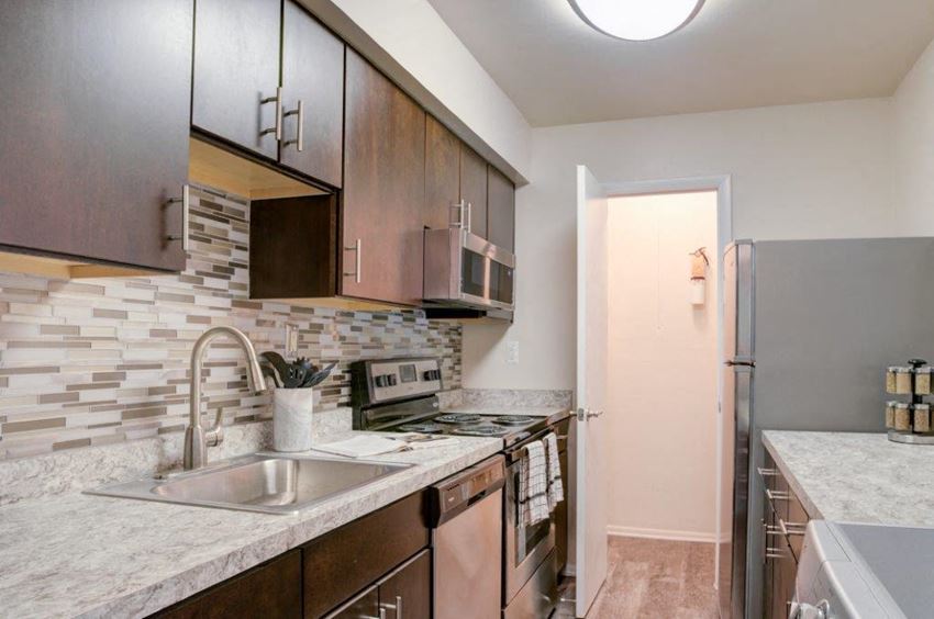 a kitchen with a sink and a refrigerator