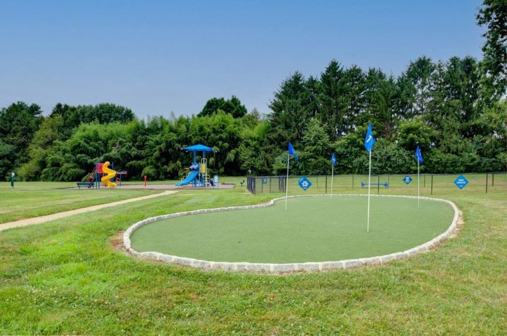 a mini golf course in a park with playground equipment