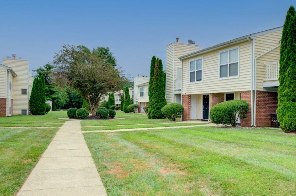 a sidewalk in front of a row of houses