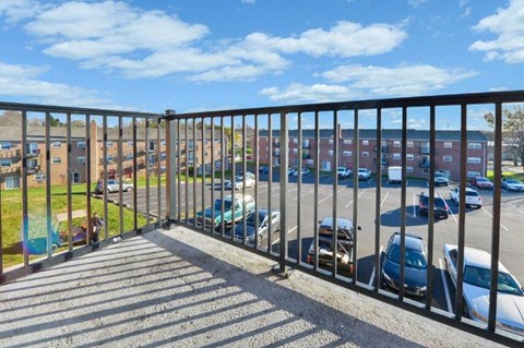 a balcony with a view of a parking lot