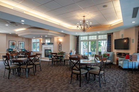 a large dining room with tables and chairs and a fireplace