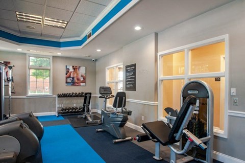 a gym with cardio equipment and weights at the enclave at woodbury