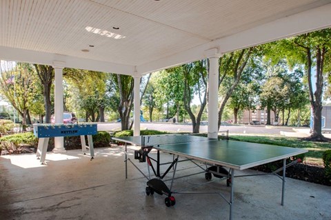 a patio with a ping pong table