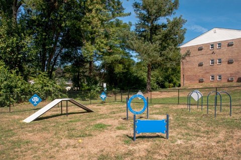 a playground with a swing set and a seesaw in a park