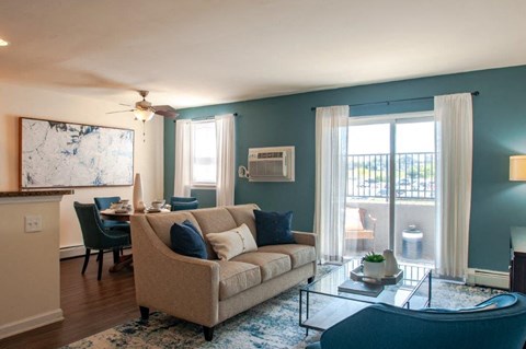 a living room with a couch and a glass table