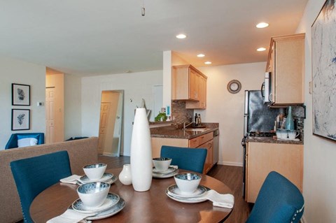 a kitchen and dining room with a table and chairs