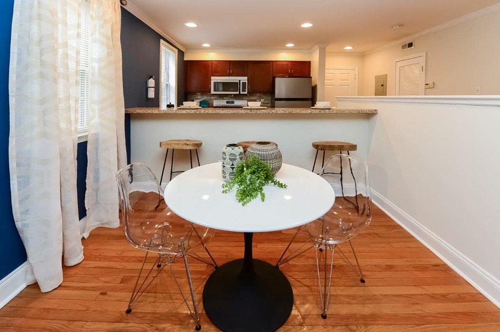 a kitchen and dining area with a table and chairs
