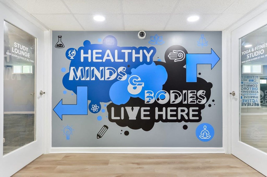 a wall in a room with logos and arrows on it