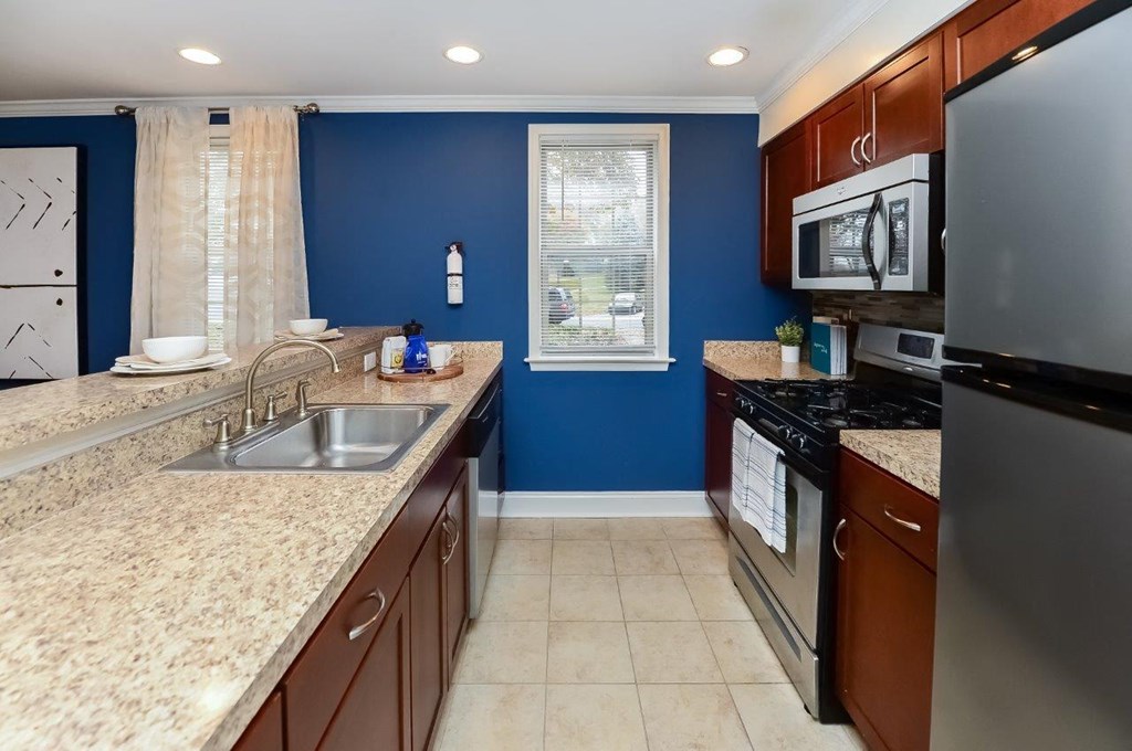a kitchen with granite counter tops and stainless steel appliances