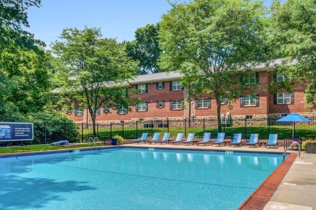 a swimming pool with a building in the background