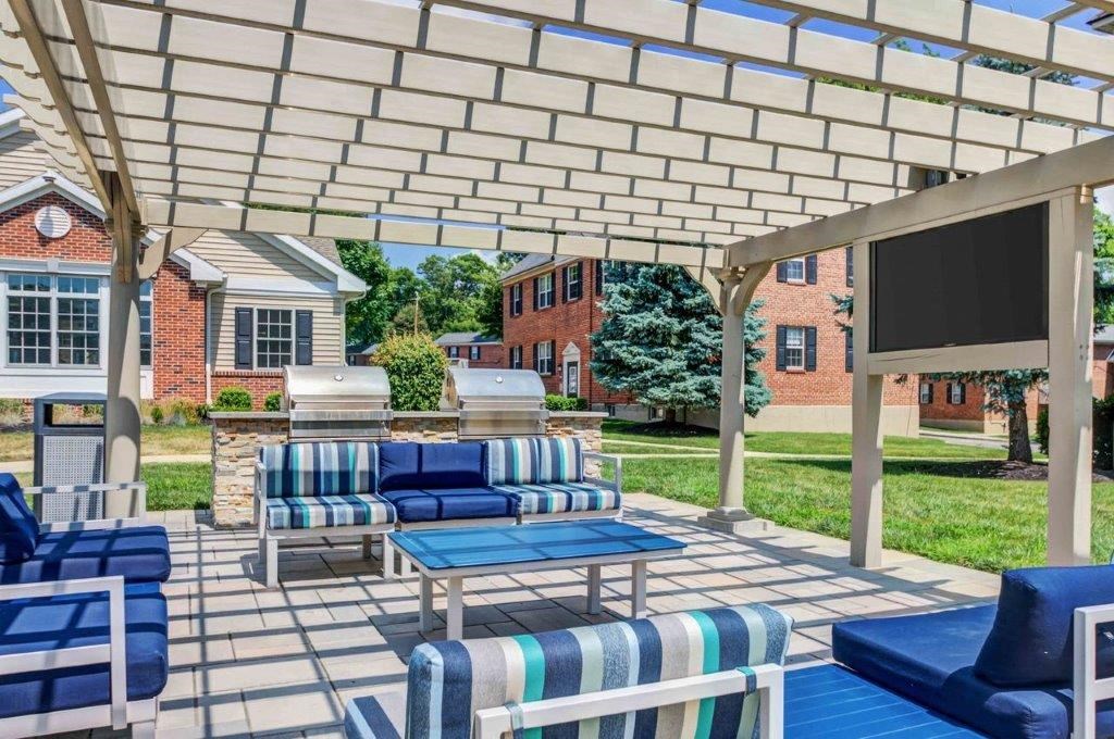 a covered patio with furniture and a tv
