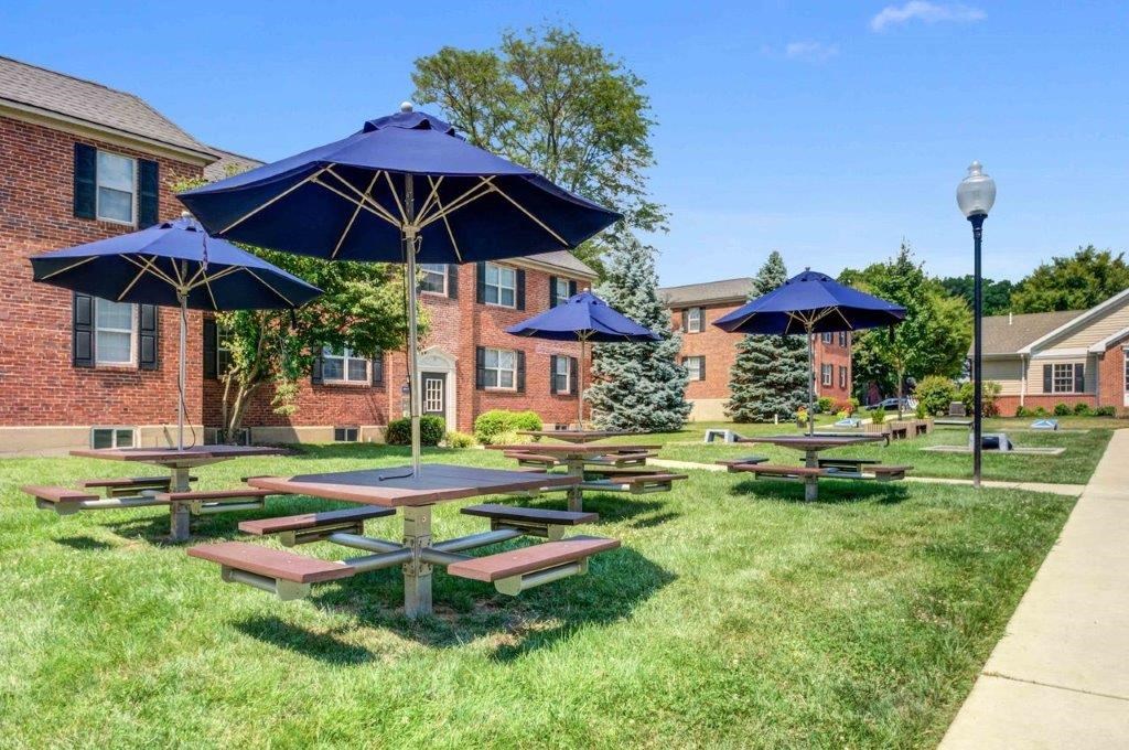 our picnic tables are in front of our building and umbrellas