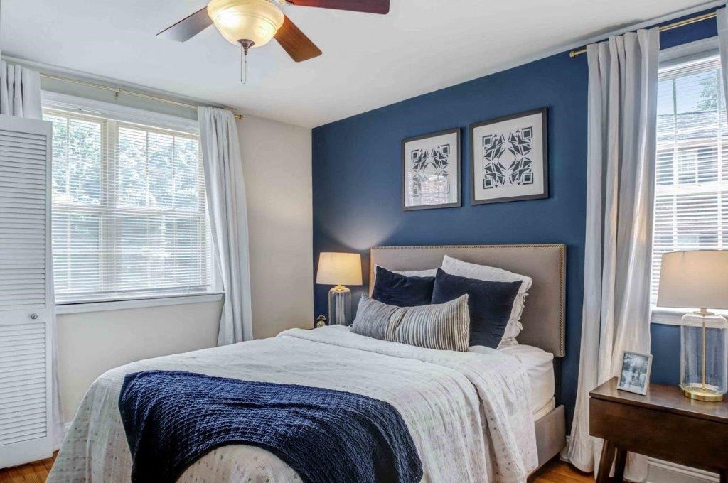 a bedroom with a bed and a ceiling fan
