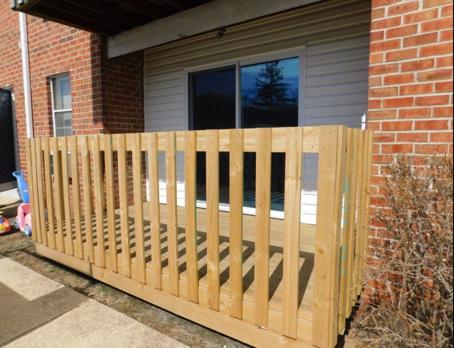 a wooden fence in front of a house