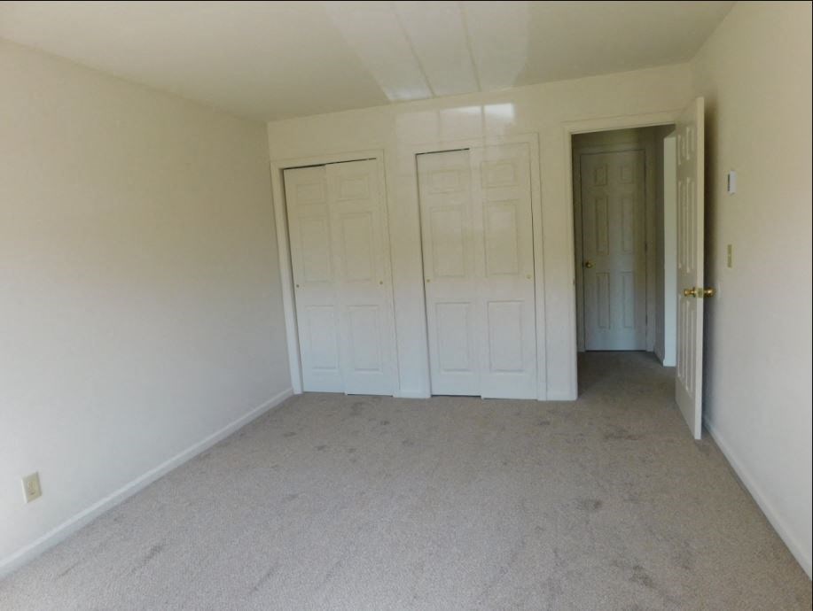 an empty room with white walls and white doors