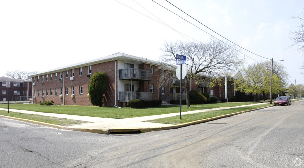 an apartment building at the corner of a street