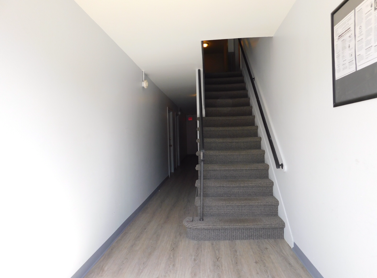 a set of stairs leading up to a hallway in a house