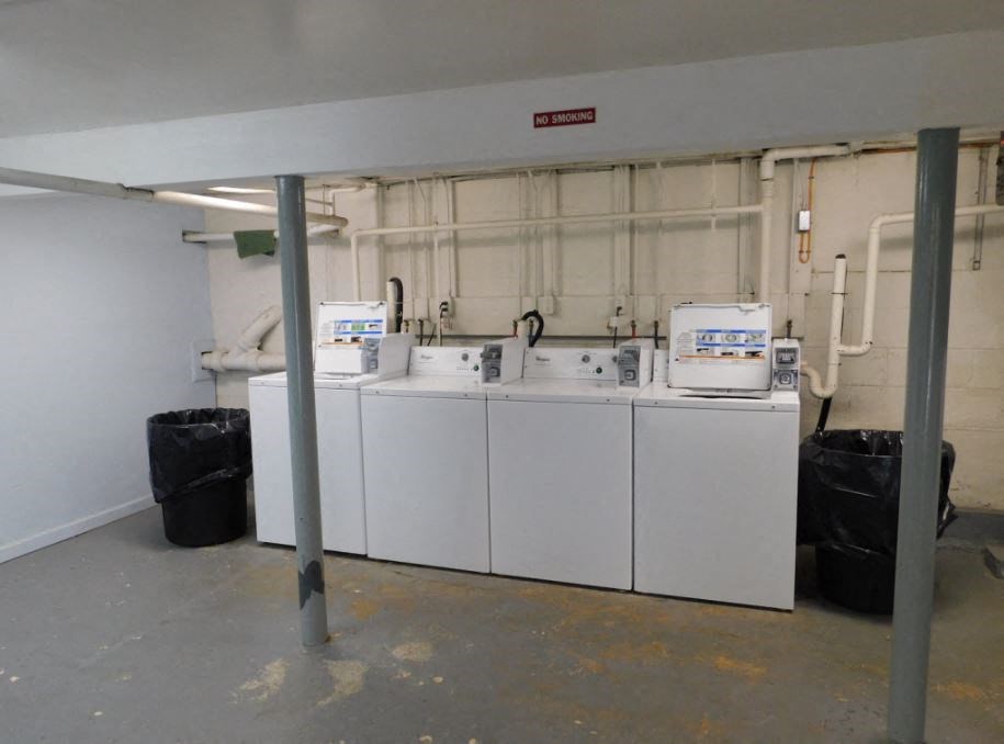 a laundry room with four washing machines in it