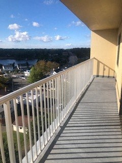 a balcony with a view of a city and a river