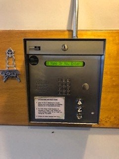 a metal fuse box sitting on a wooden wall