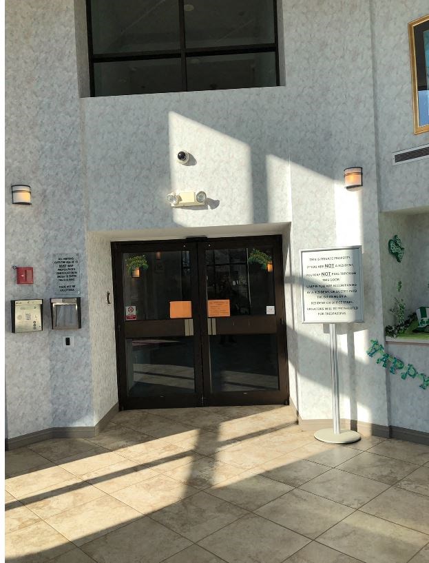 the entrance to a building with a black door