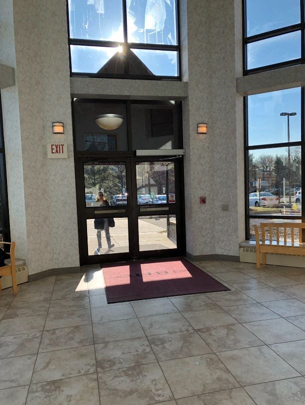 a person is walking through the door of a building