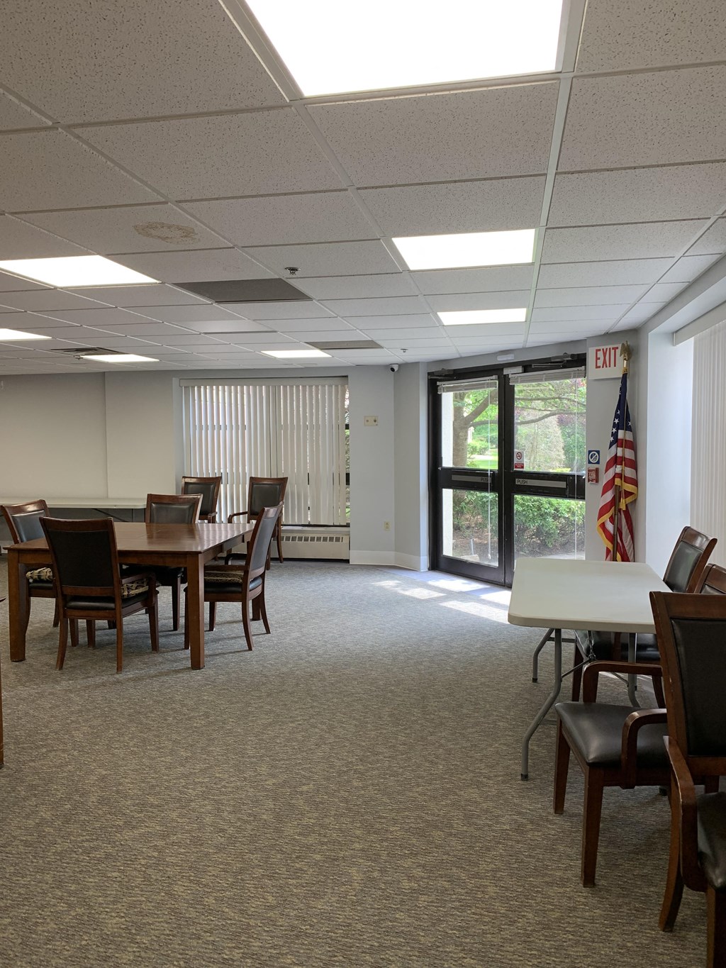 a room with tables and chairs and a sliding glass door
