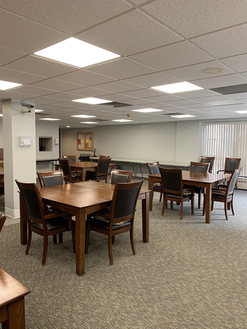a dining room with tables and chairs in a room