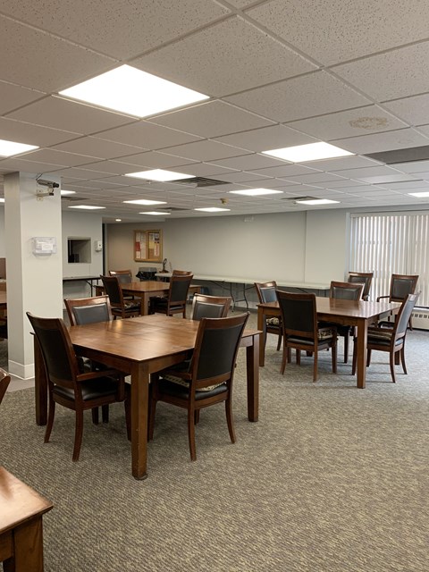 a dining room with tables and chairs in a room