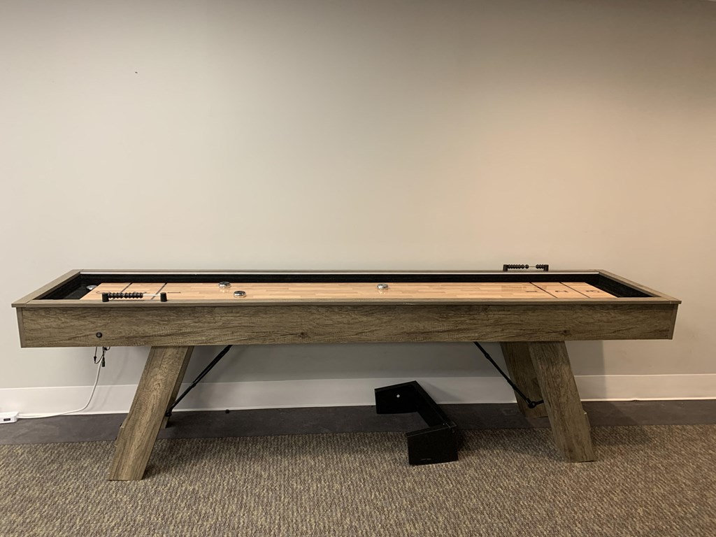 a pool table with a wooden base in a room