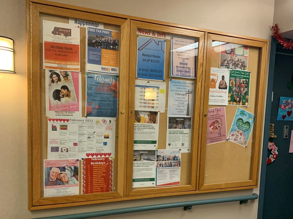 a display case filled with informational papers on a wall
