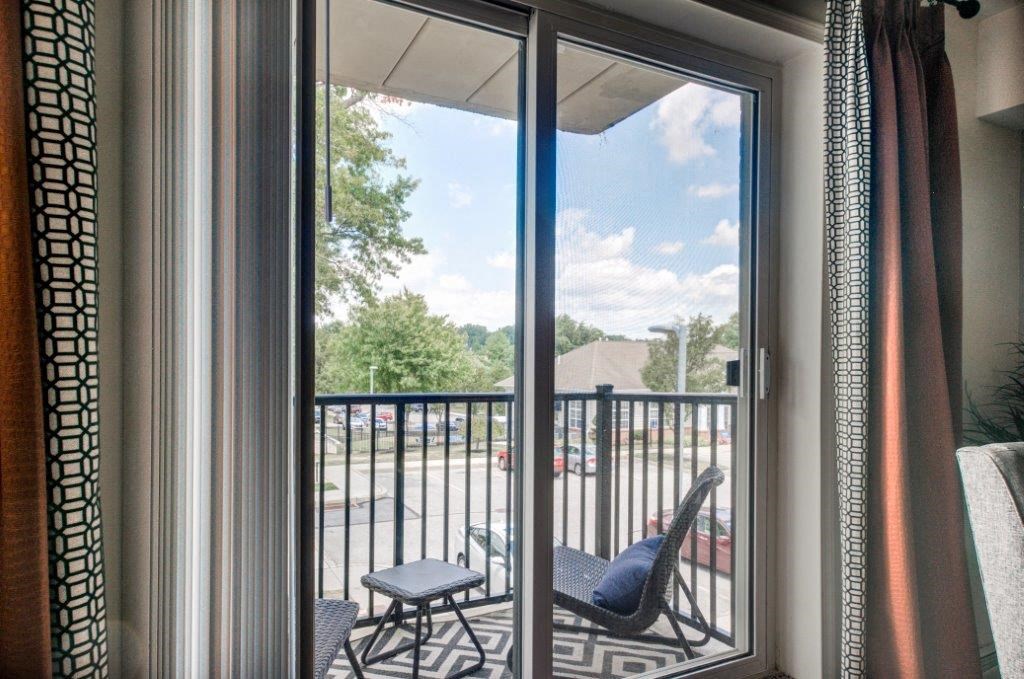 a balcony with a chair and a balcony door