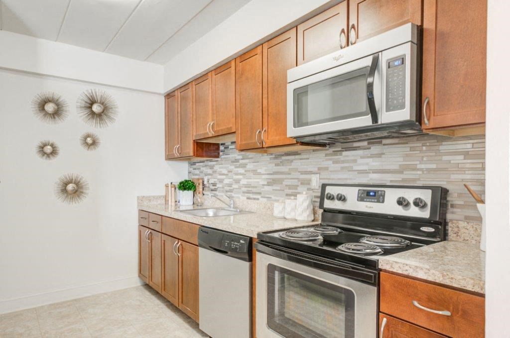 a kitchen with stainless steel appliances and wooden cabinets