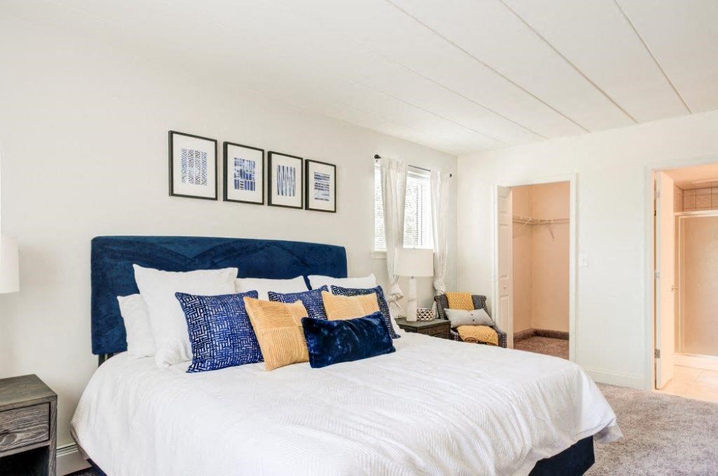 a bedroom with a large bed and a closet