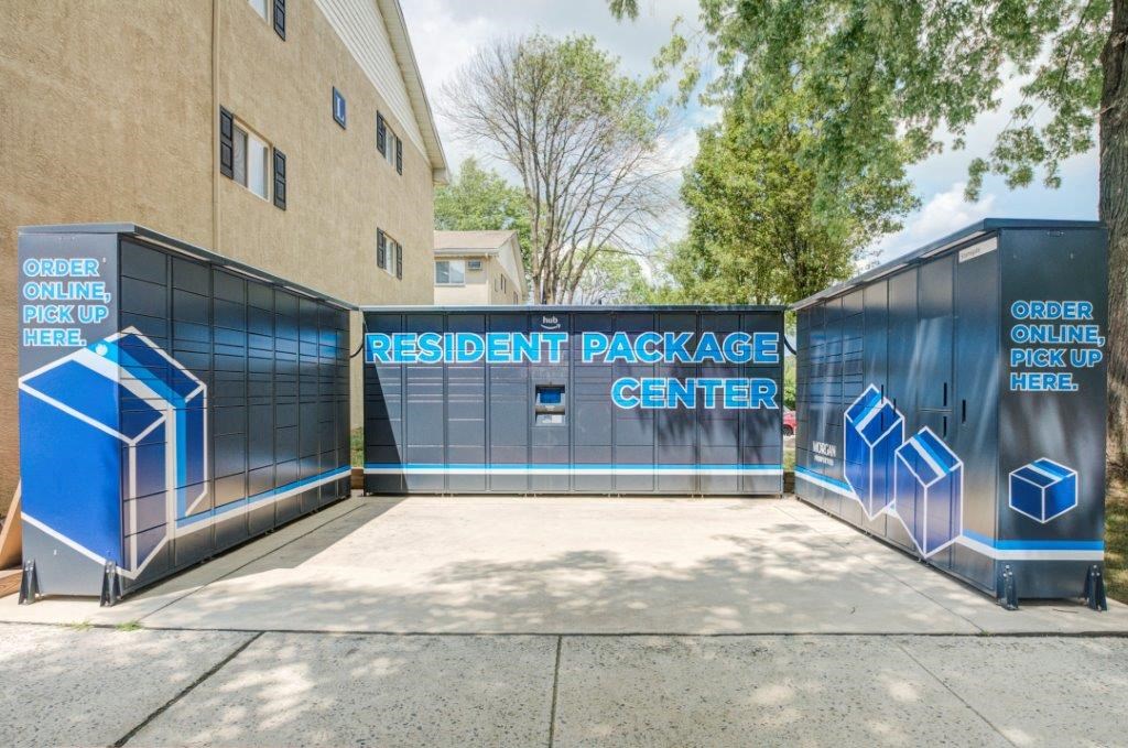 the entrance to the residential package center with a blue fence