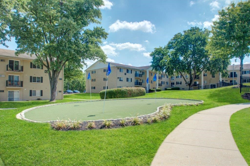 a basketball court in front of an apartment building
