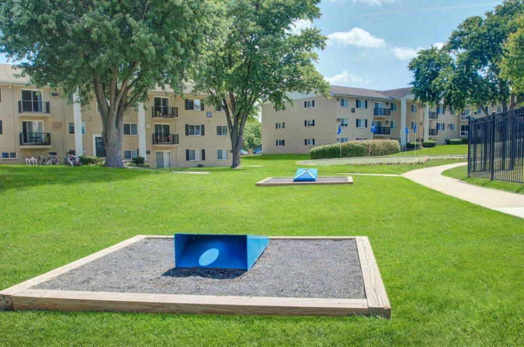 a playground with two blue discs in the middle of the grass