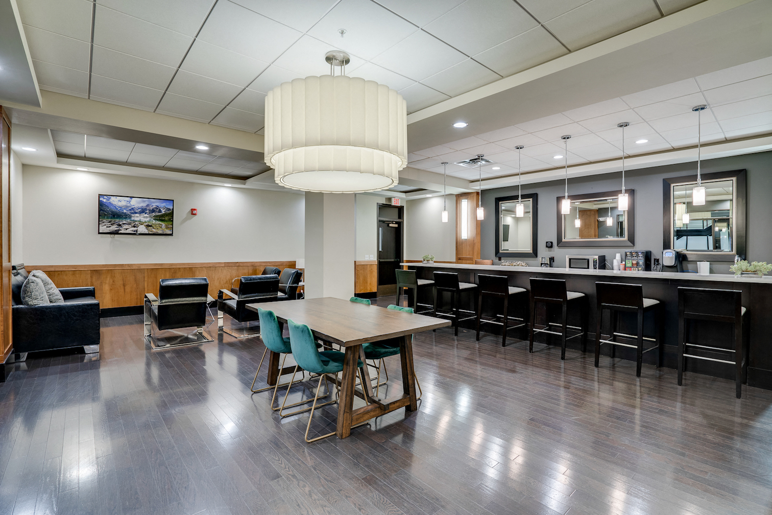 a dining room with tables and chairs and a kitchen