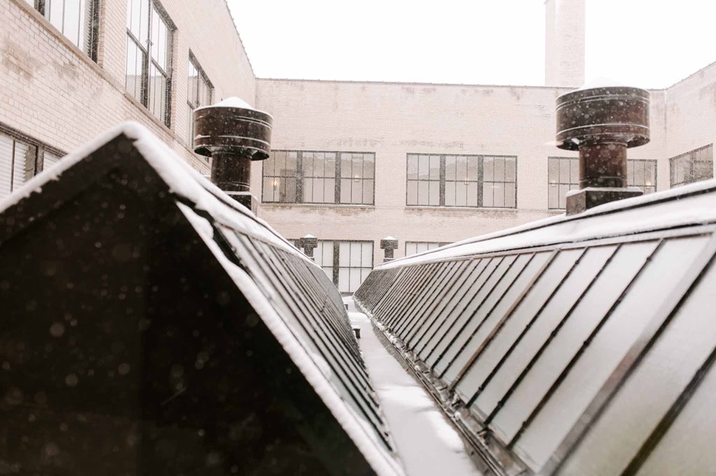 a view of the roof of a building in the snow