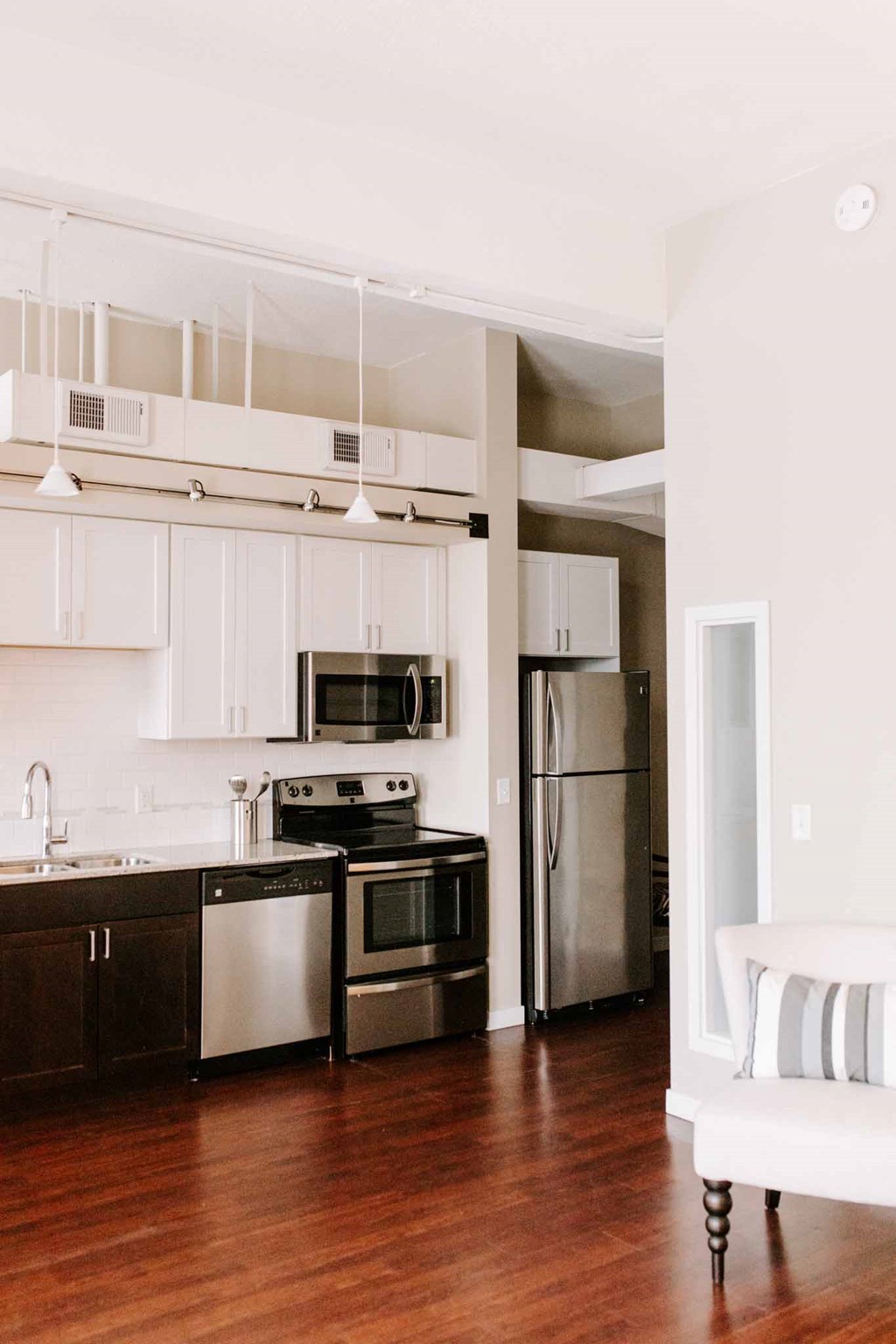 a kitchen with stainless steel appliances and white cabinets