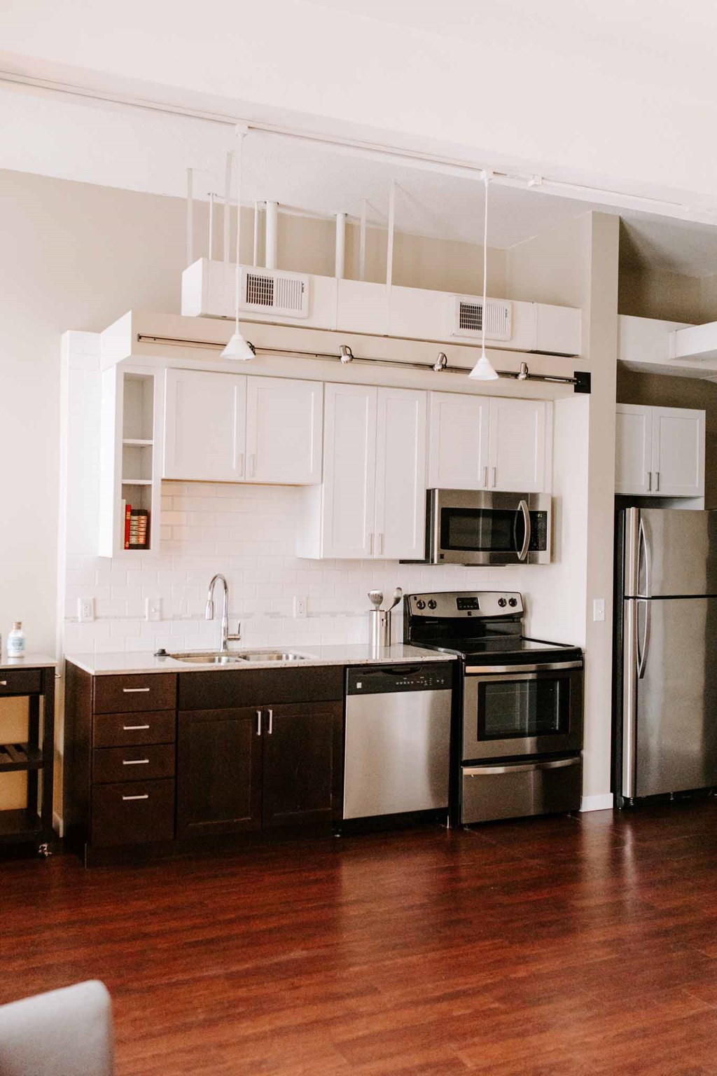 a kitchen with white cabinets and stainless steel appliances