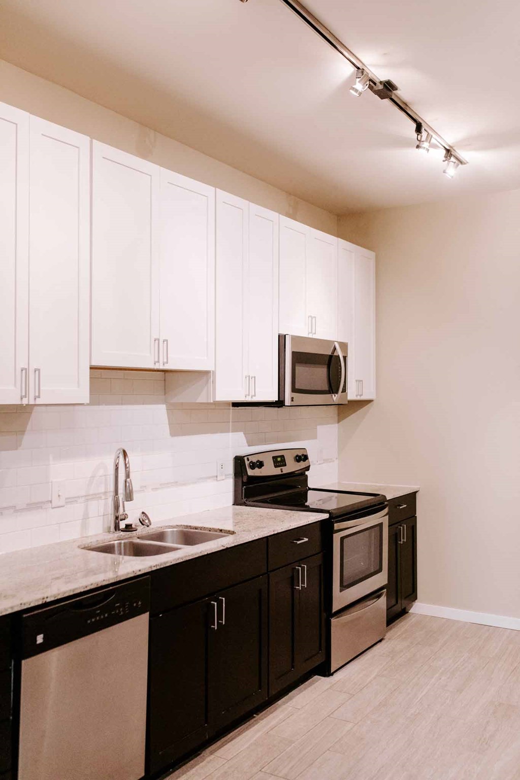 a kitchen with black and white cabinets and a sink