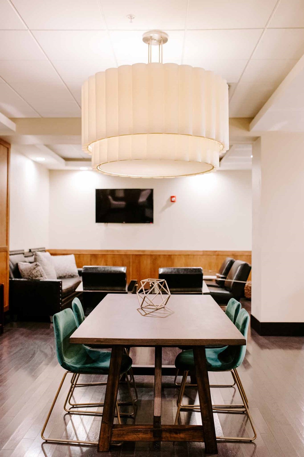 a dining room with a table and chairs and a chandelier
