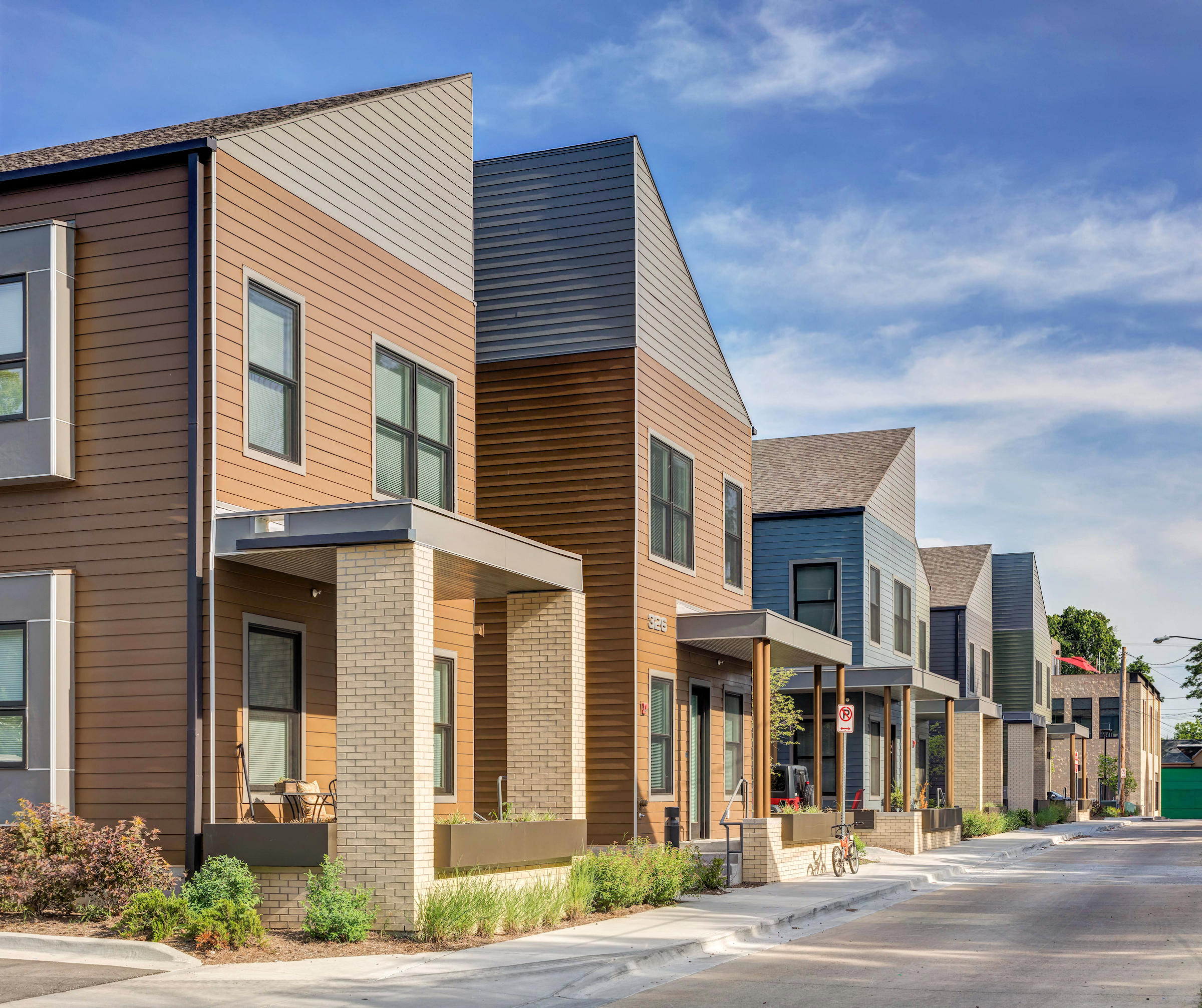 a row of townhouses on the side of a street